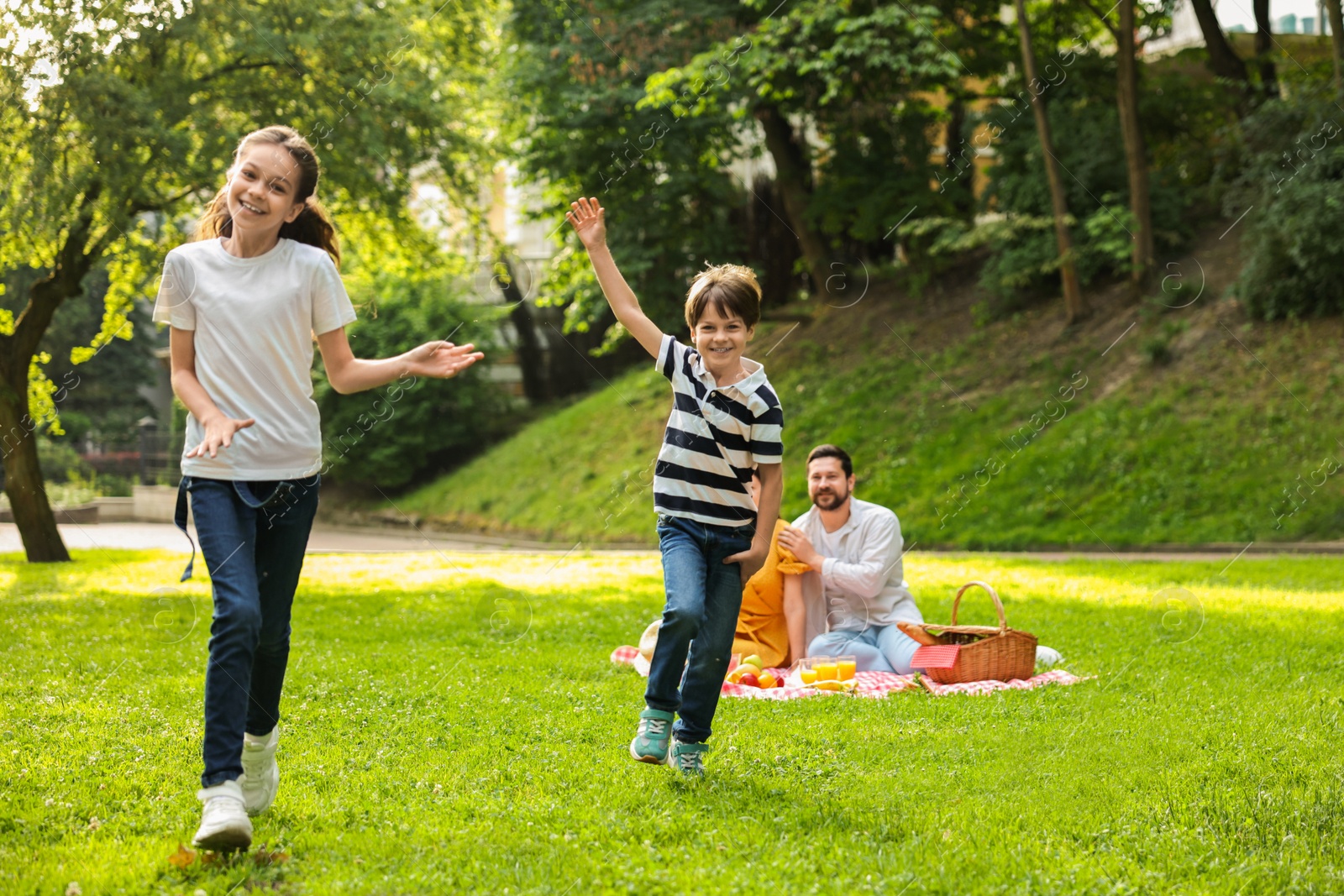 Photo of Happy children playing during family picnic outdoors