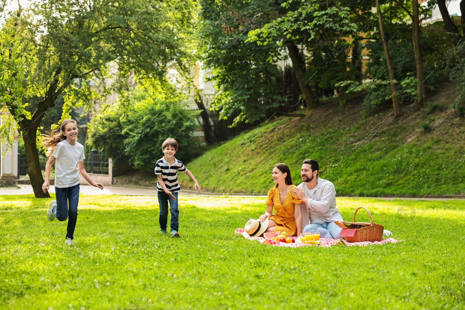 Photo of Happy children playing during family picnic outdoors