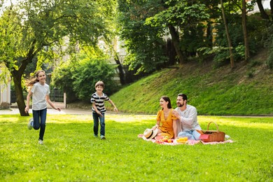 Photo of Happy children playing during family picnic outdoors