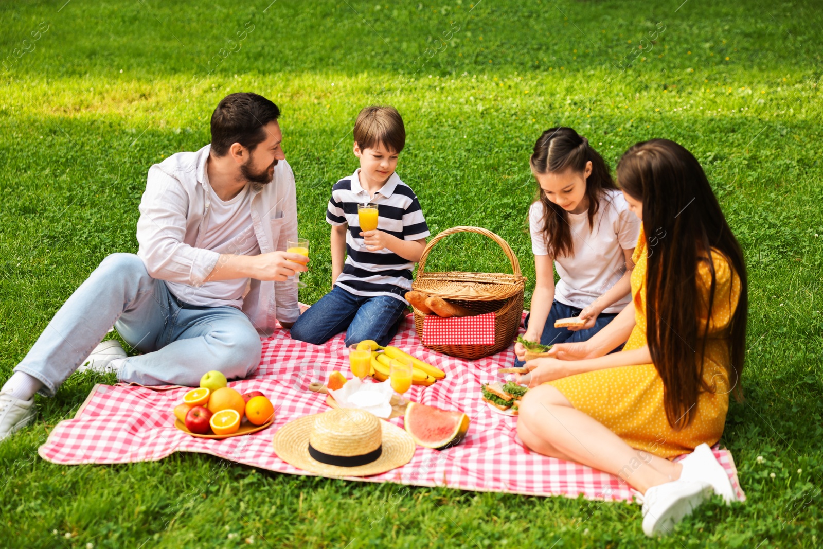 Photo of Lovely family having picnic together in park