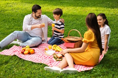 Family picnic. Parents and their children spending time together outdoors