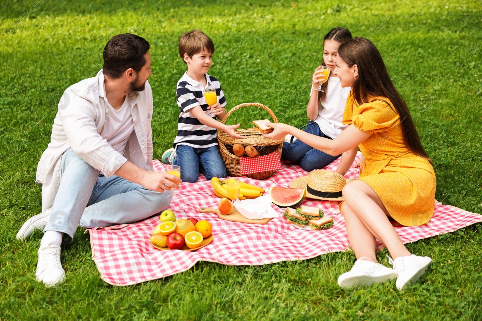 Photo of Lovely family having picnic together in park