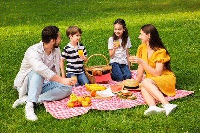 Family picnic. Parents and their children spending time together outdoors