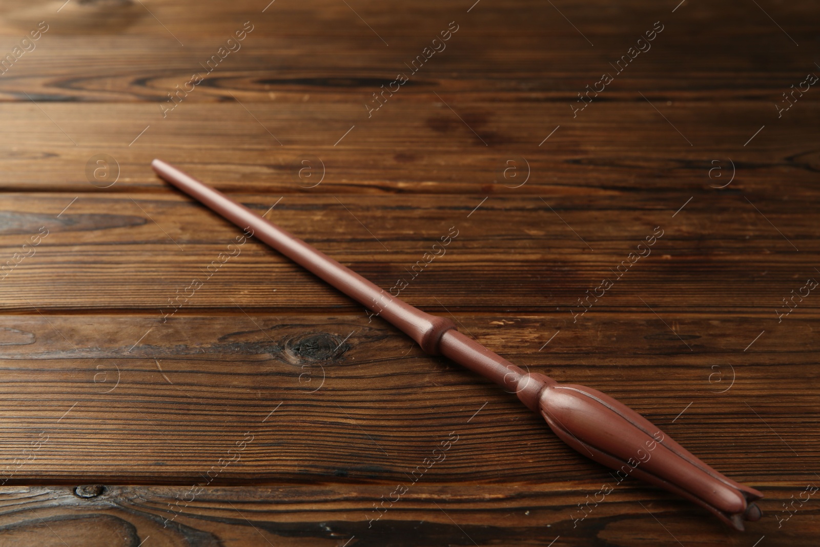 Photo of One old magic wand on wooden table