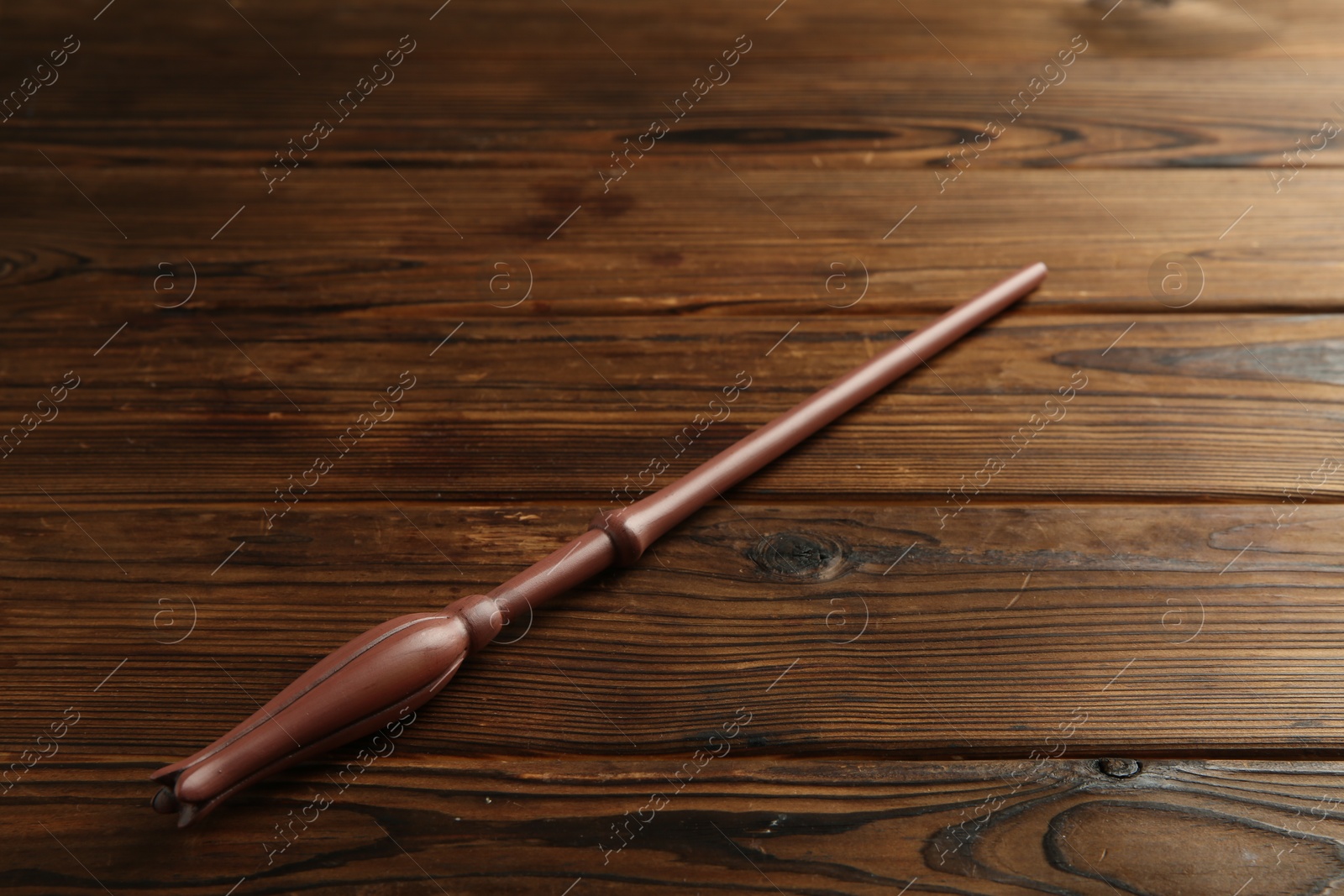 Photo of One old magic wand on wooden table