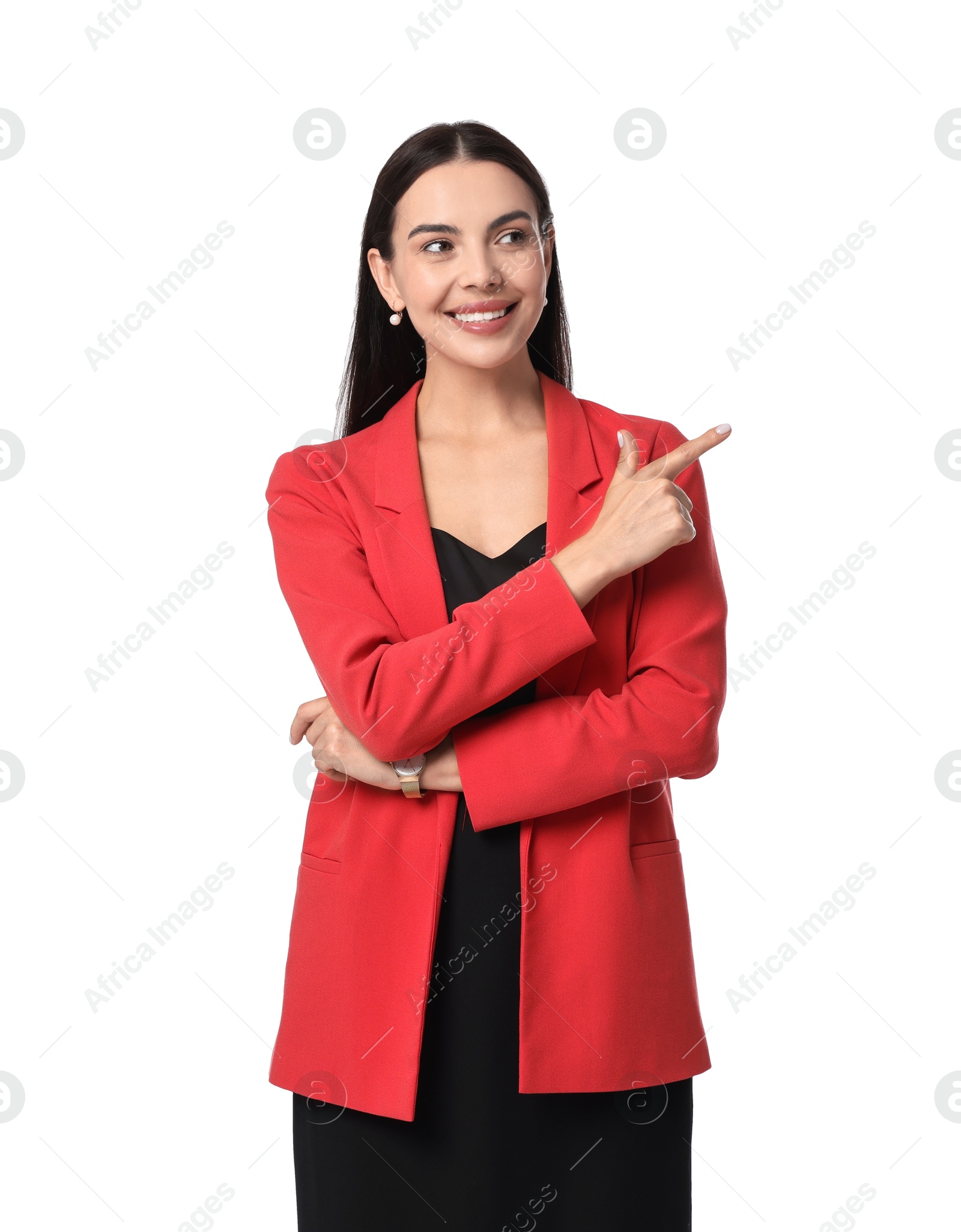 Photo of Beautiful woman in red jacket and black dress pointing at something on white background