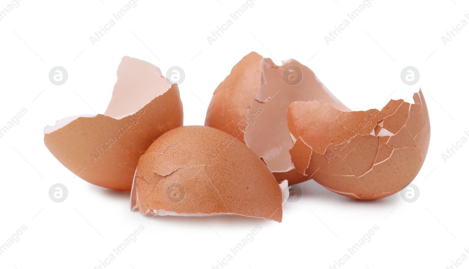 Photo of Pieces of broken eggshells isolated on white