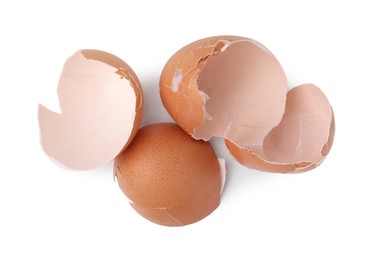 Photo of Broken eggshells isolated on white, above view