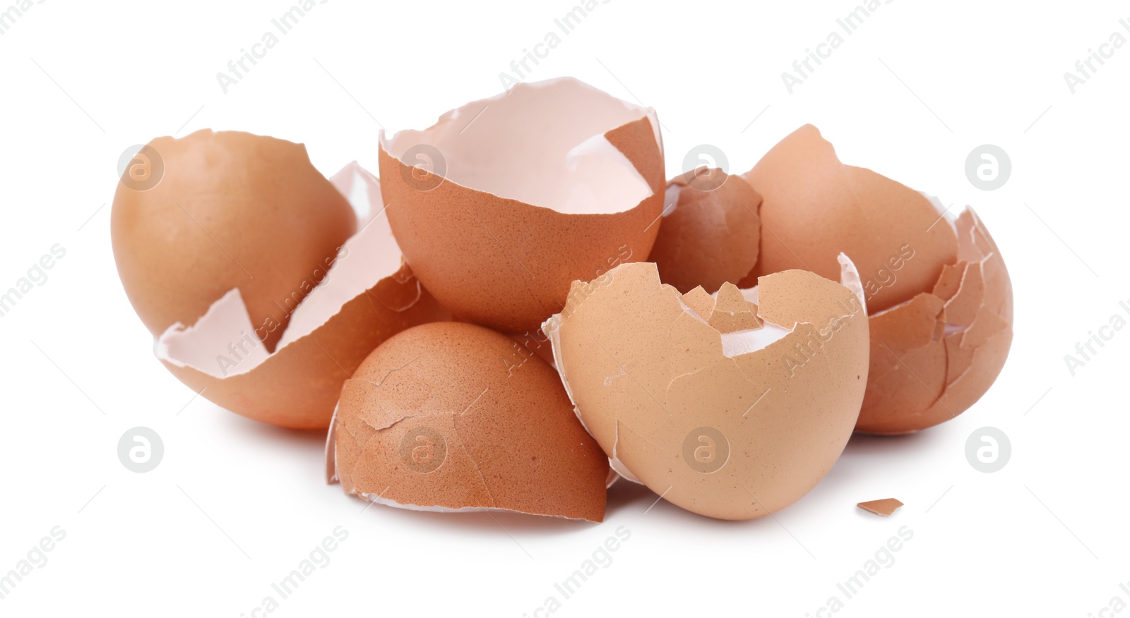 Photo of Pile of broken eggshells isolated on white