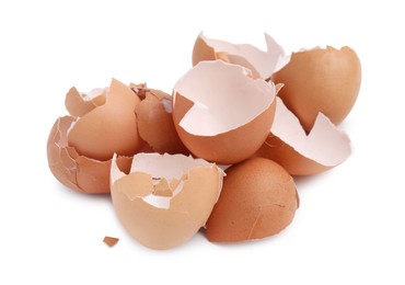 Photo of Pile of broken eggshells isolated on white