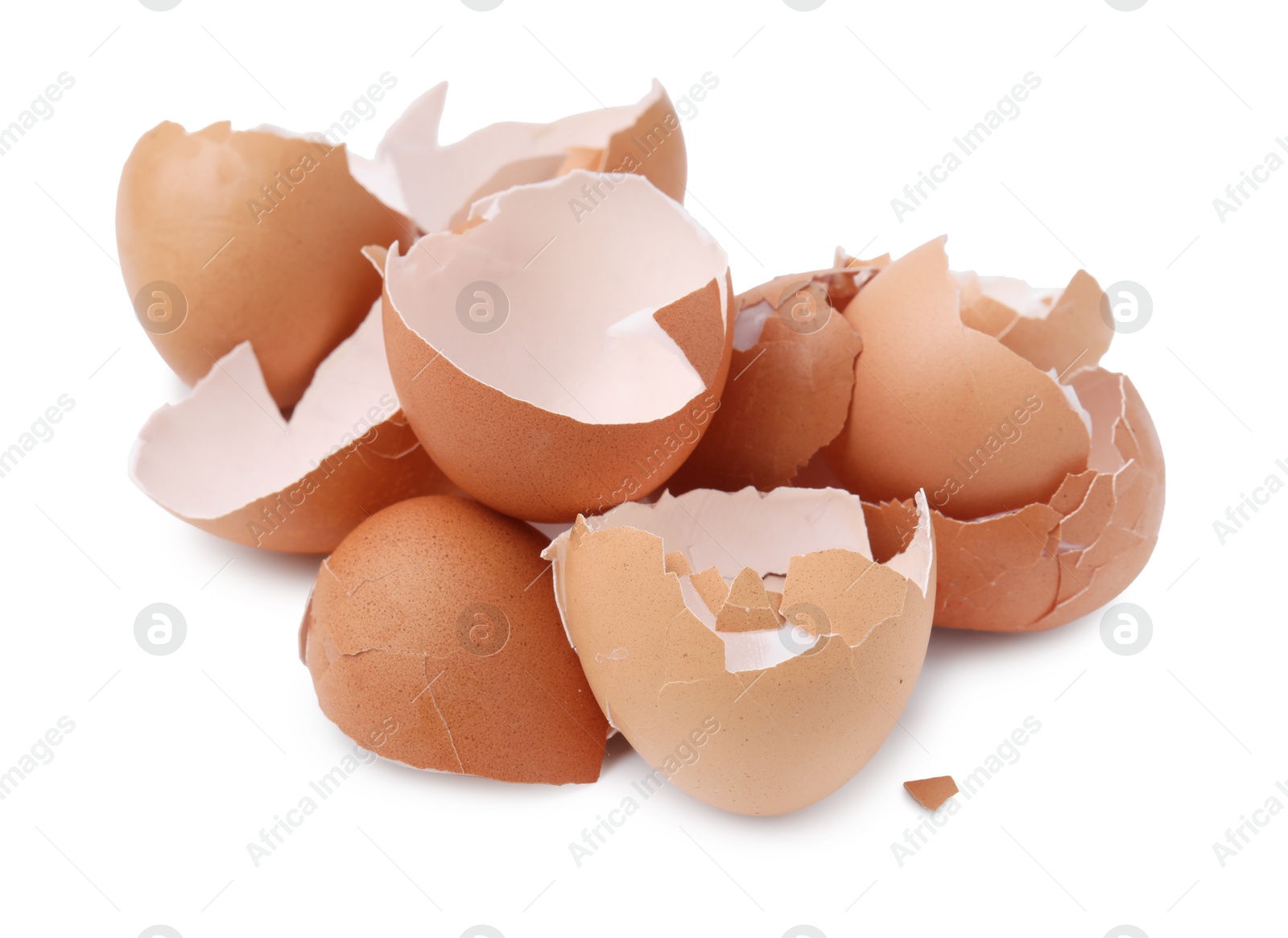 Photo of Pile of broken eggshells isolated on white