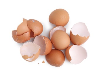 Photo of Pile of broken eggshells isolated on white, top view