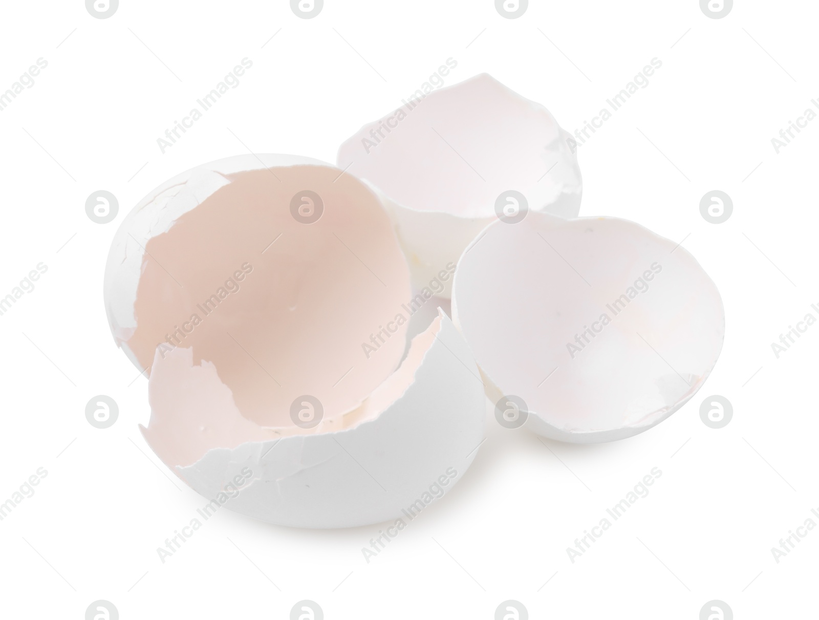 Photo of Pieces of broken eggshells isolated on white