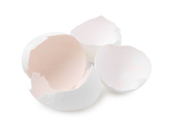 Photo of Pieces of broken eggshells isolated on white