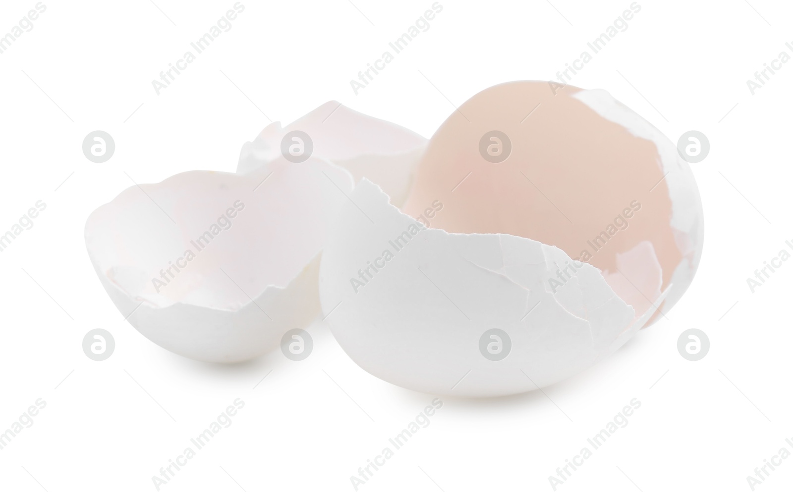 Photo of Pieces of broken eggshells isolated on white