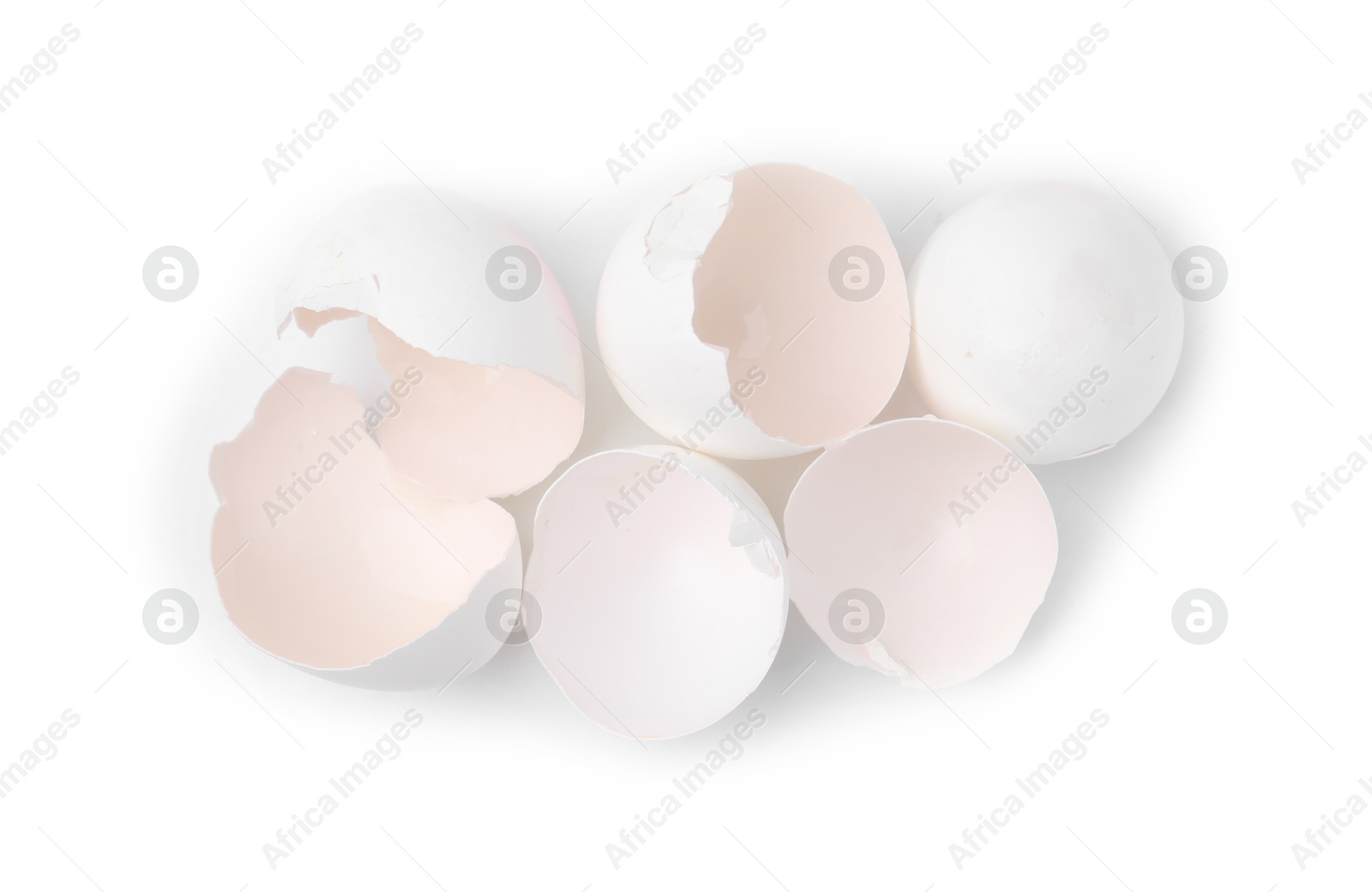 Photo of Pile of broken eggshells isolated on white, top view