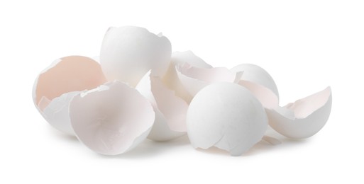 Photo of Pile of broken eggshells isolated on white