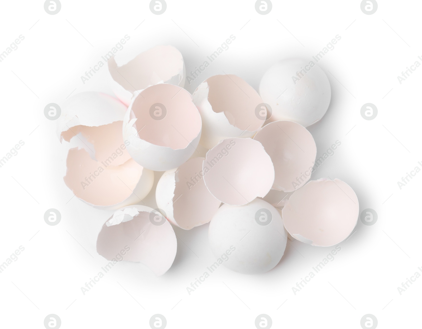 Photo of Pile of broken eggshells isolated on white, top view