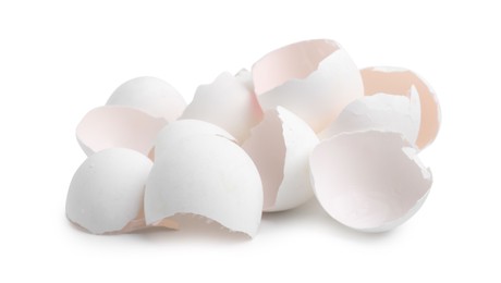 Photo of Pile of broken eggshells isolated on white