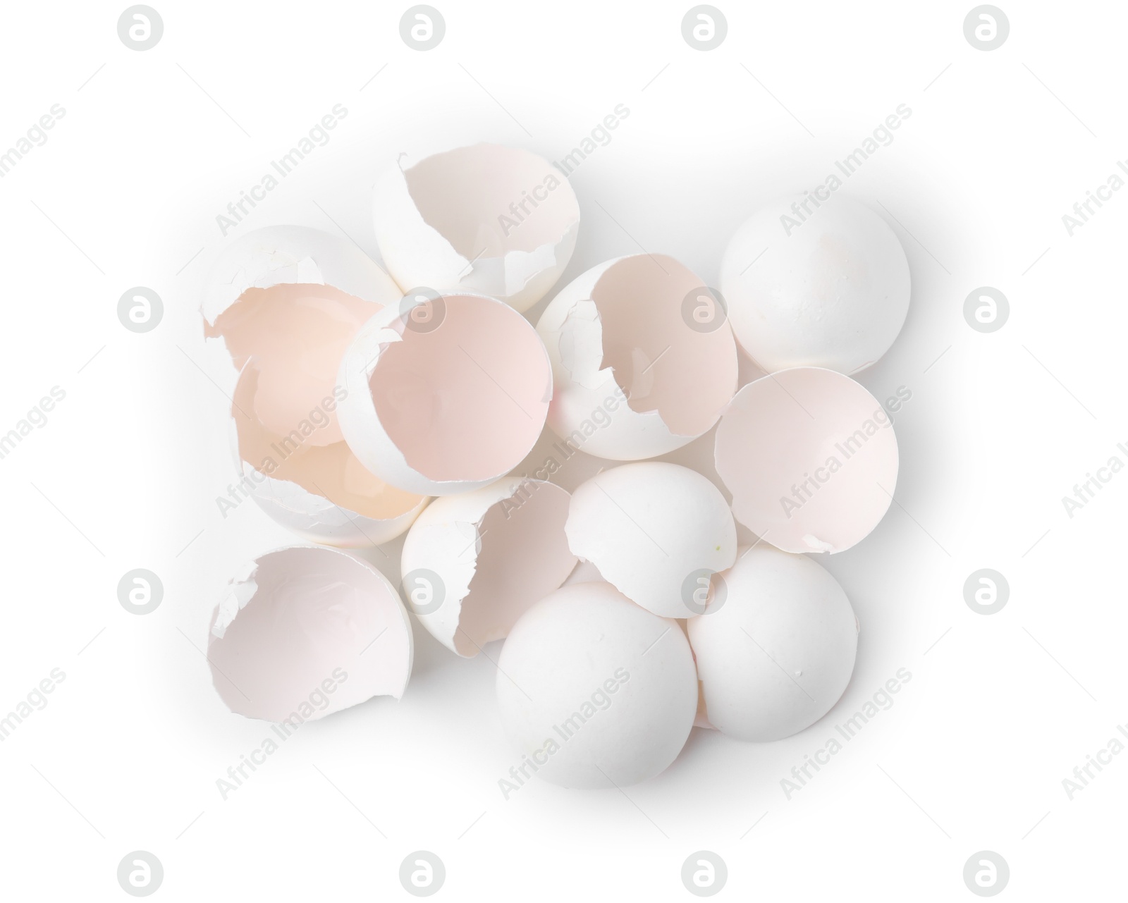 Photo of Pile of broken eggshells isolated on white, top view