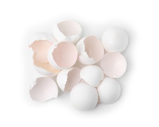 Photo of Pile of broken eggshells isolated on white, top view