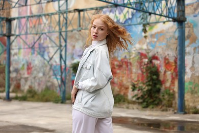 Portrait of beautiful young woman outdoors. Hip hop dancer