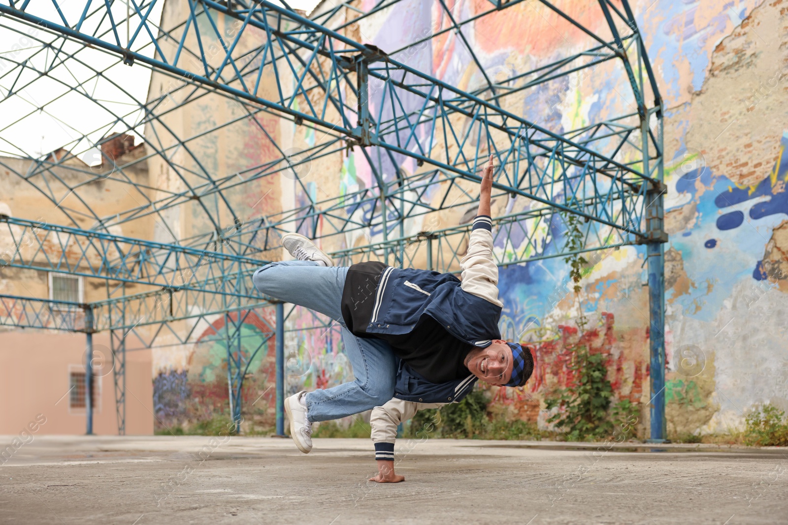 Image of Man dancing hip hop outdoors, low angle view