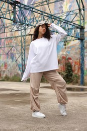 Image of Portrait of beautiful young woman outdoors. Hip hop dancer