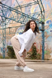 Portrait of beautiful young woman outdoors. Hip hop dancer