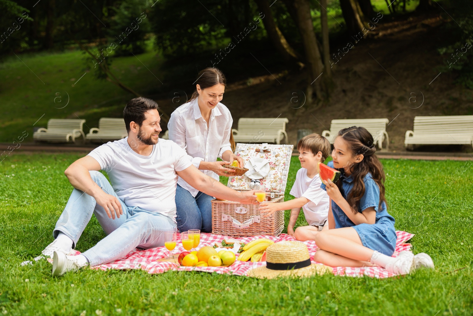 Photo of Happy family having picnic together in park