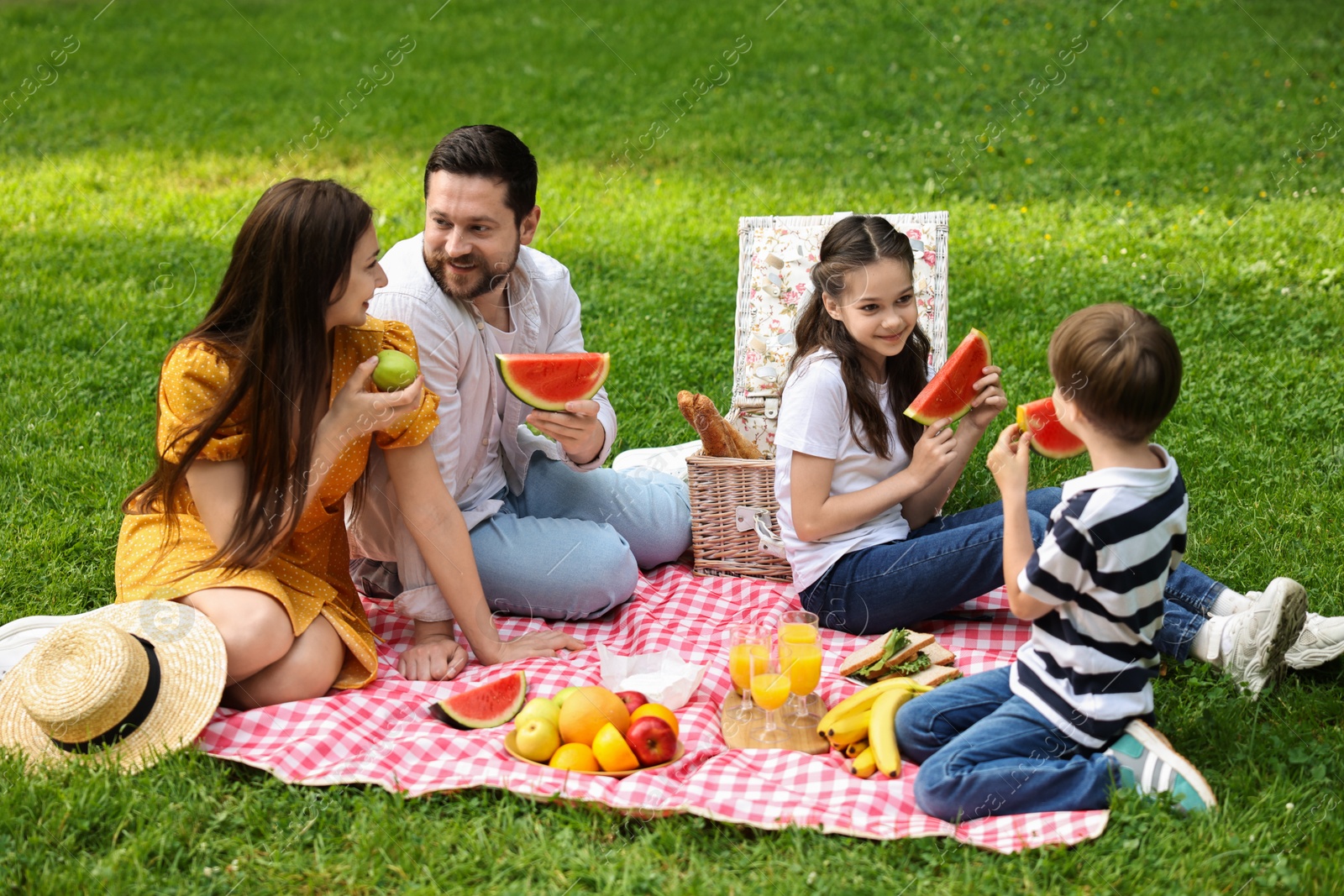 Photo of Happy family having picnic together in park