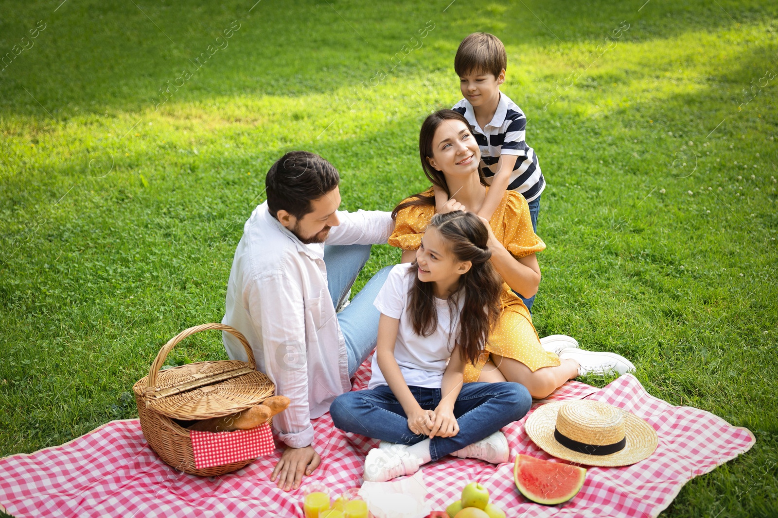 Photo of Happy family having picnic together in park