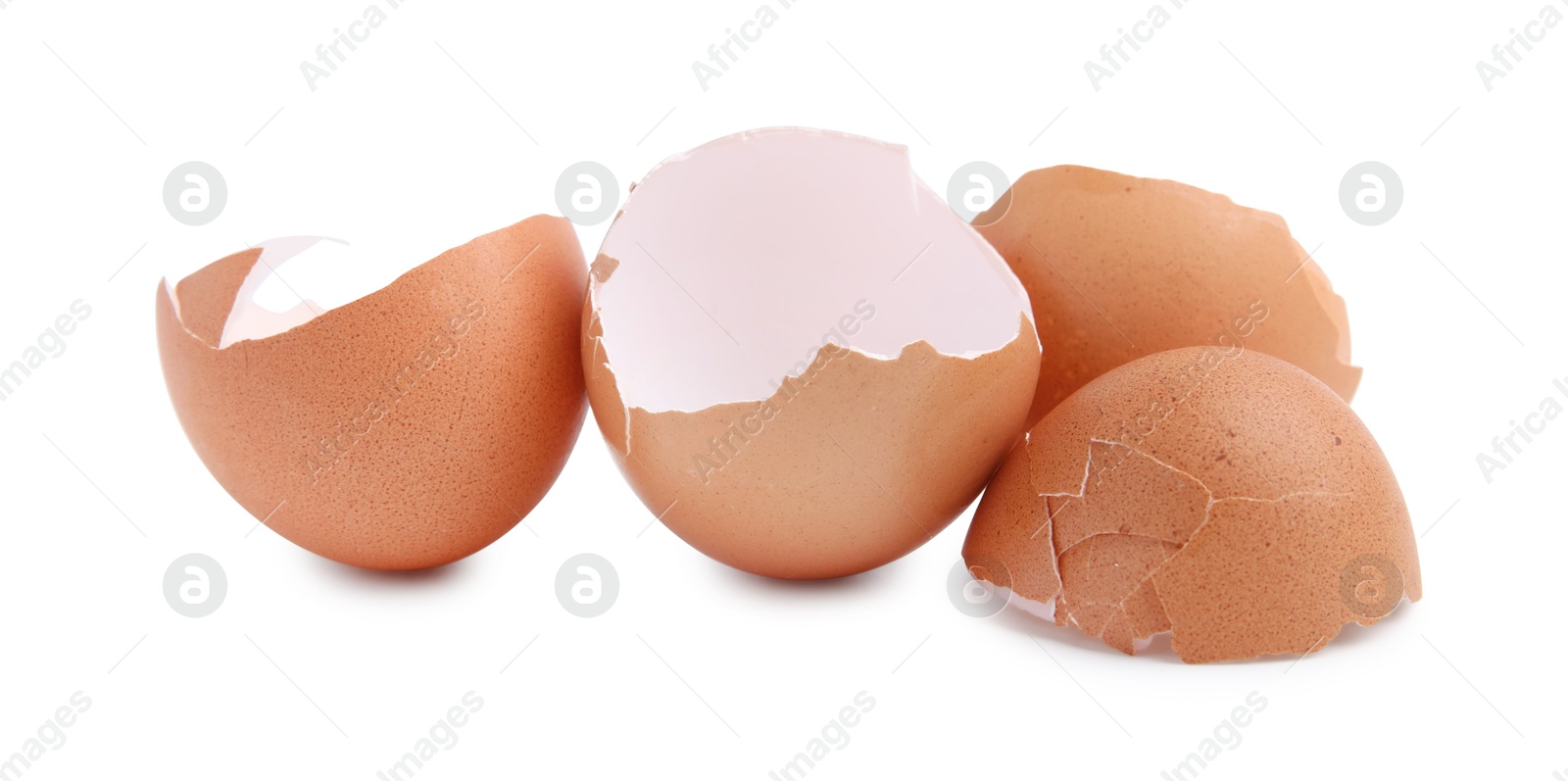 Photo of Pieces of broken eggshells isolated on white