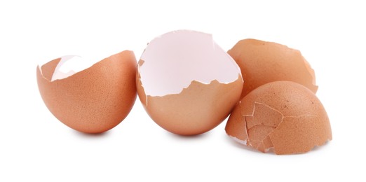 Photo of Pieces of broken eggshells isolated on white