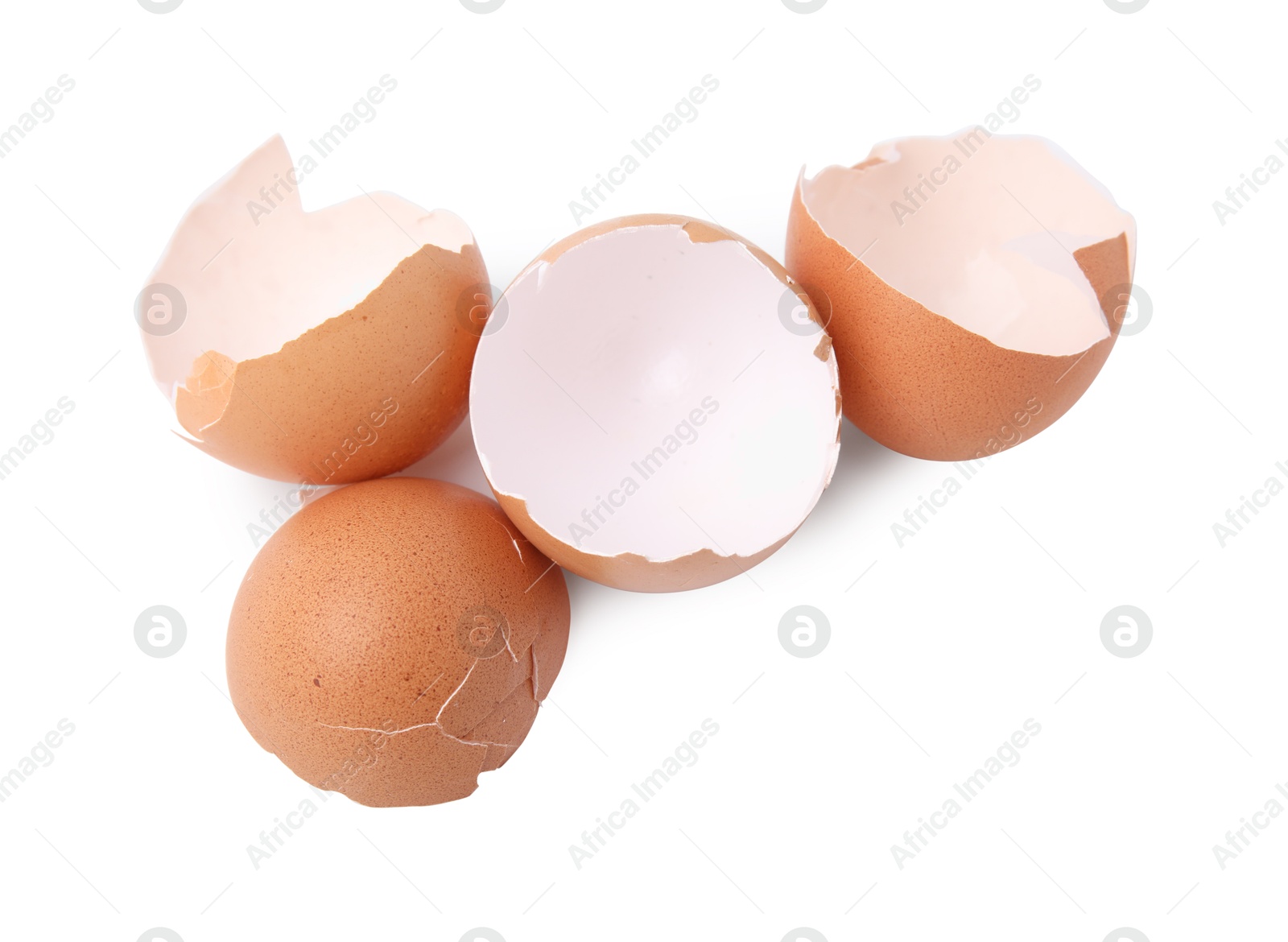 Photo of Pieces of broken eggshells isolated on white, above view