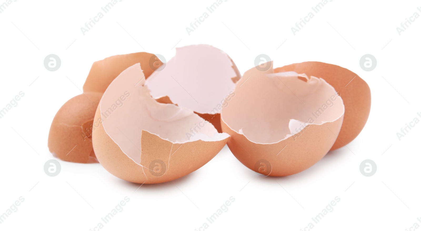 Photo of Pieces of broken eggshells isolated on white