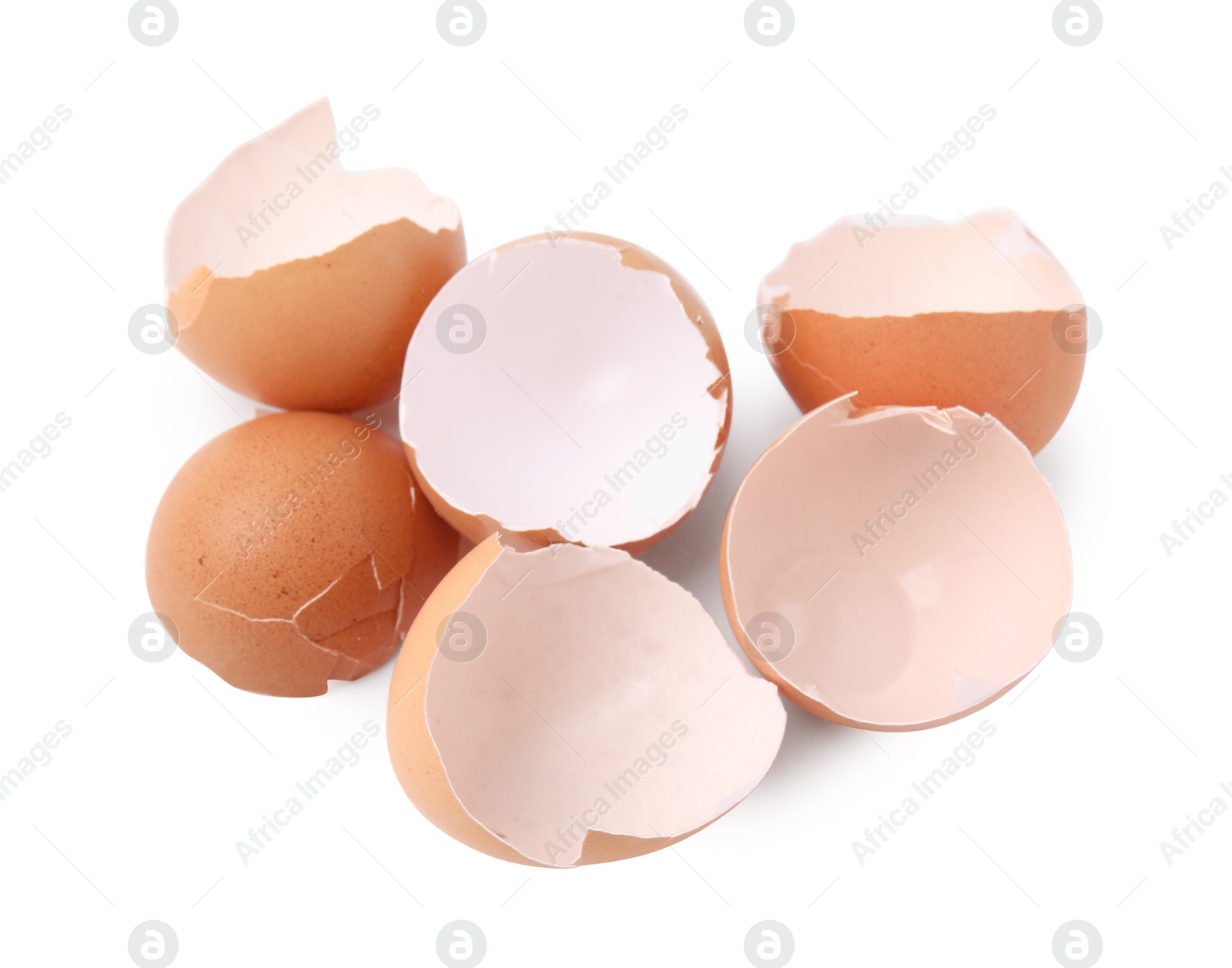 Photo of Pieces of broken eggshells isolated on white, above view