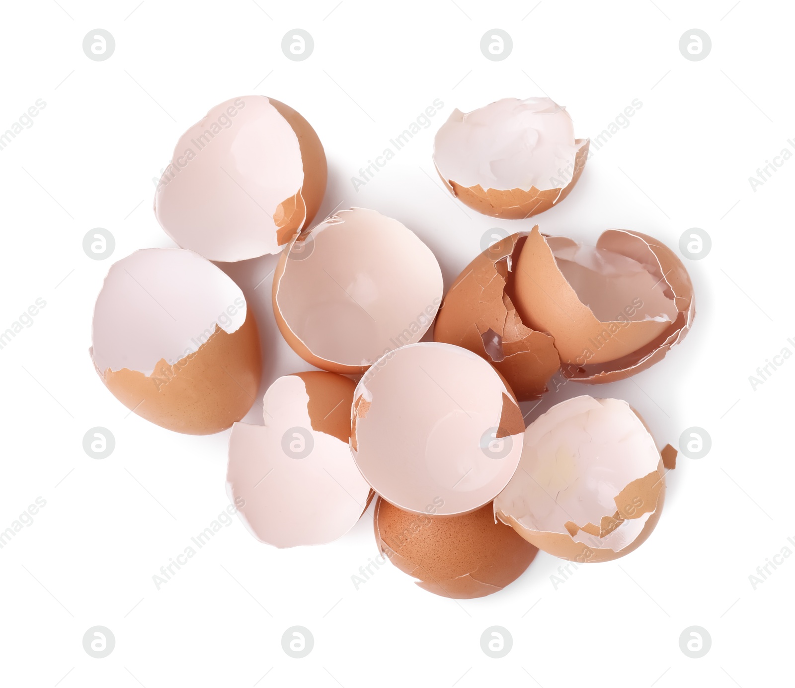 Photo of Pile of broken eggshells isolated on white, top view