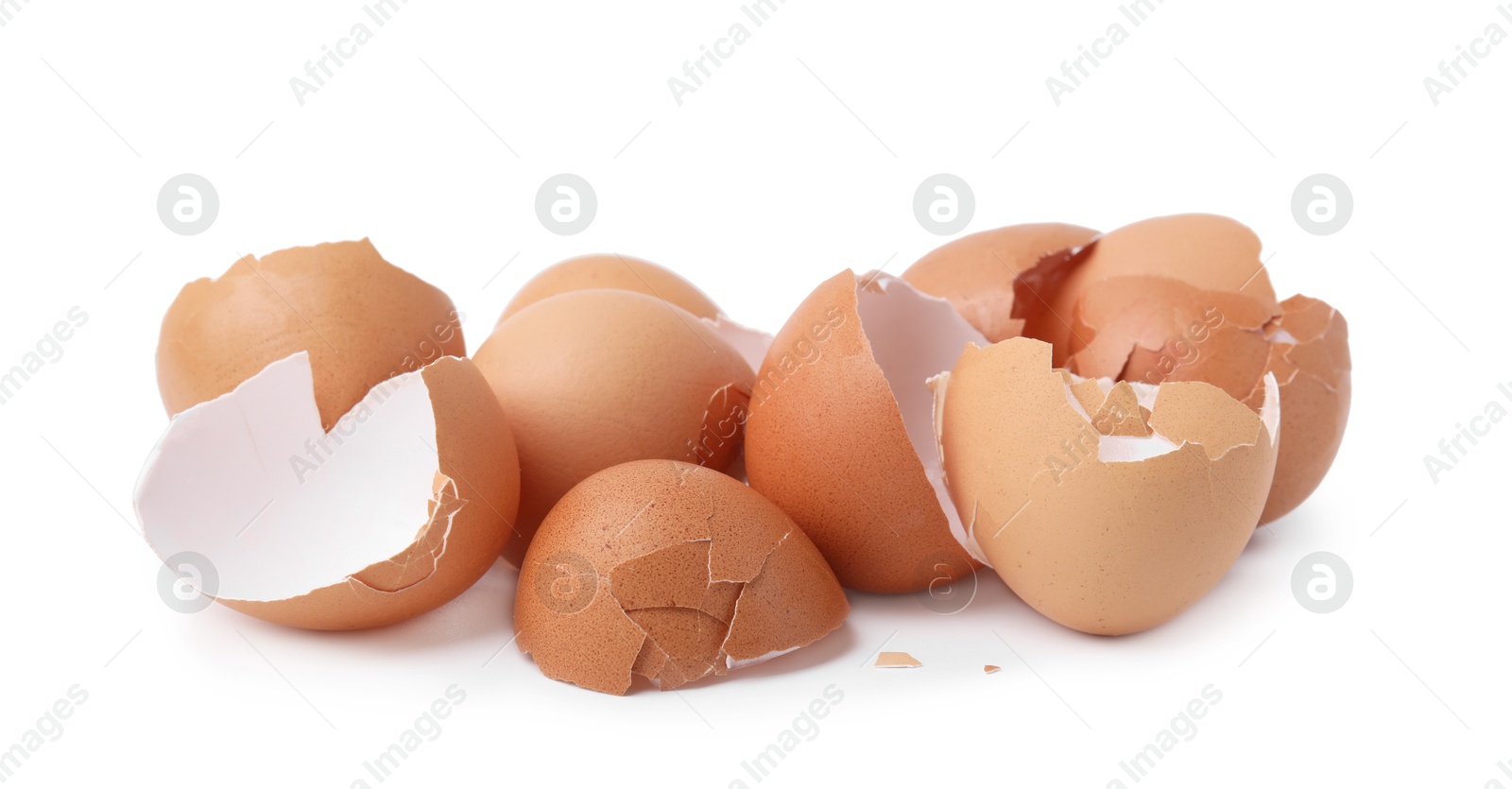 Photo of Pile of broken eggshells isolated on white