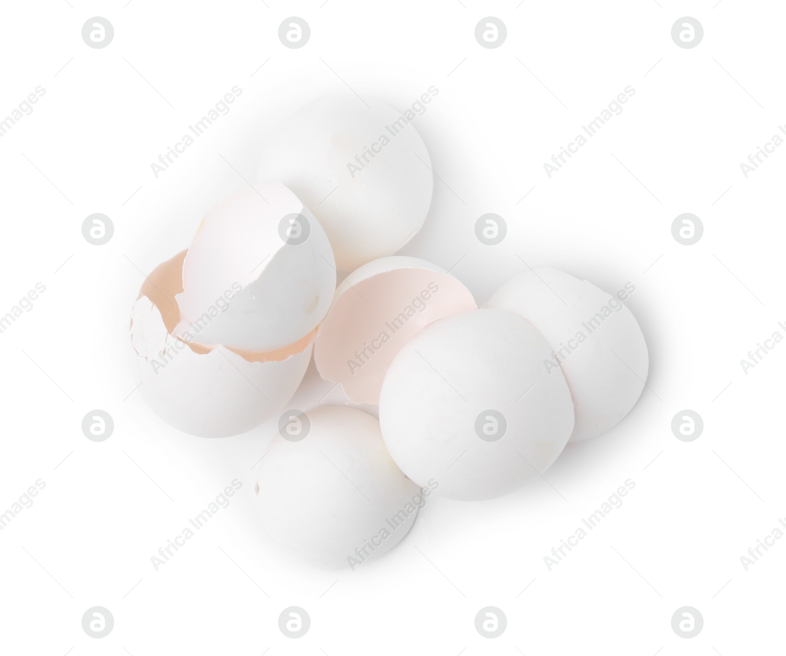 Photo of Pile of broken eggshells isolated on white, top view