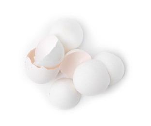 Photo of Pile of broken eggshells isolated on white, top view