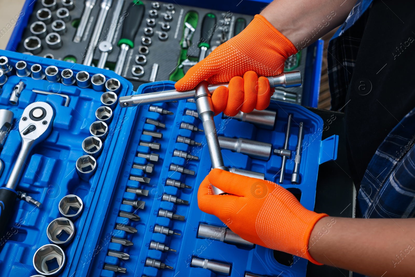 Photo of Auto mechanic with different tools at automobile repair shop, closeup