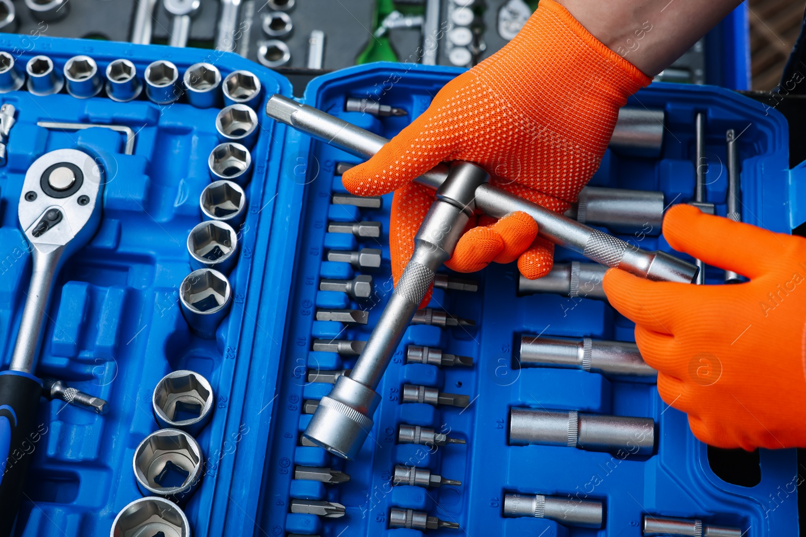 Photo of Auto mechanic with different tools at automobile repair shop, closeup