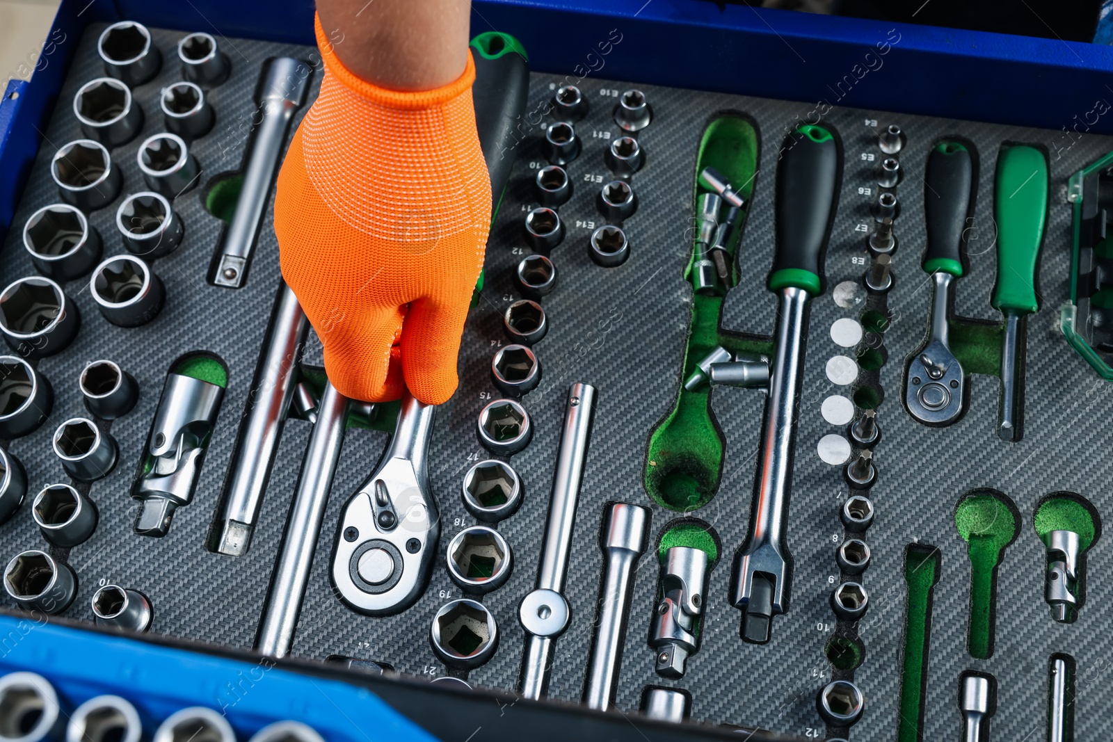 Photo of Auto mechanic with different tools at automobile repair shop, top view