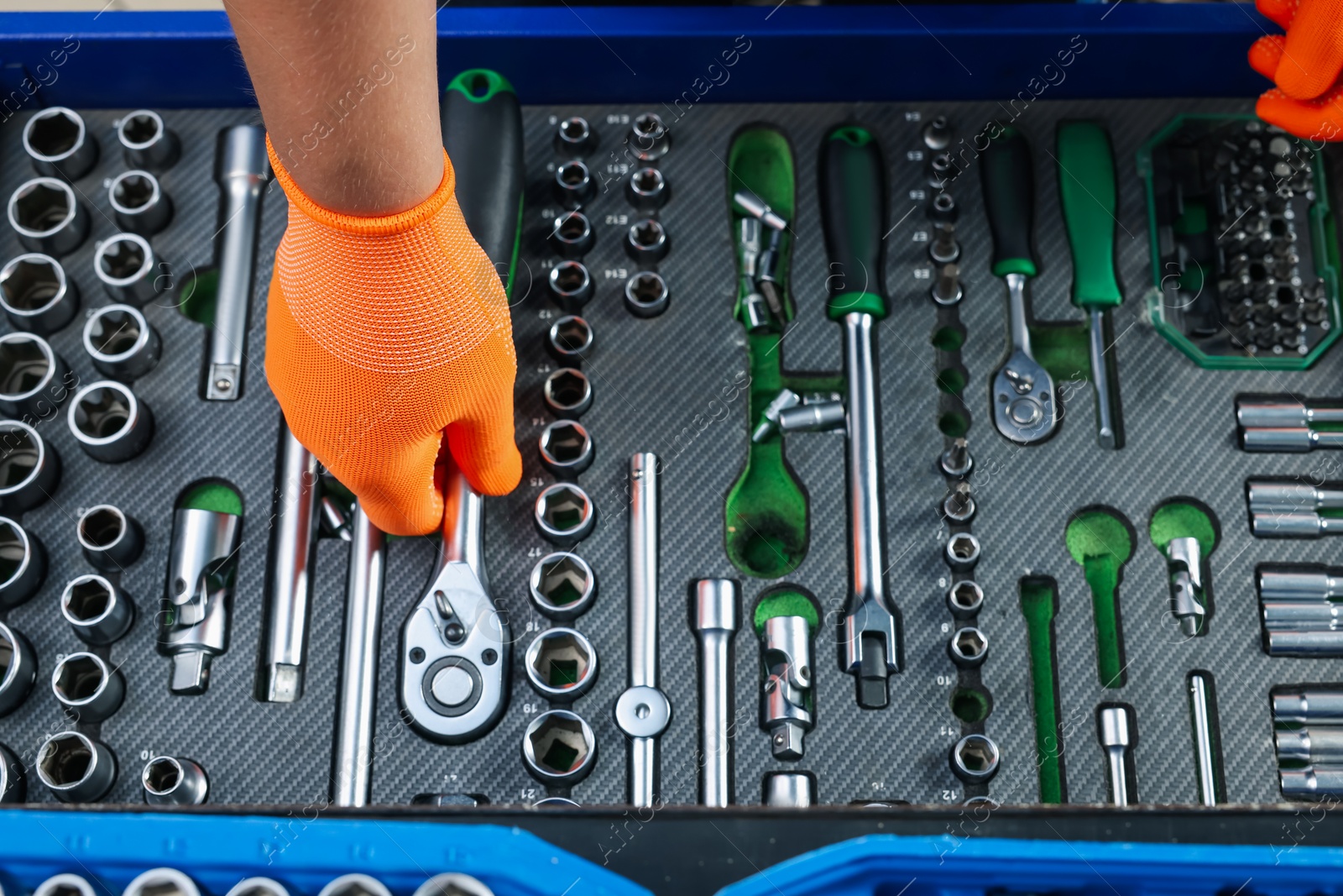 Photo of Auto mechanic with different tools at automobile repair shop, top view