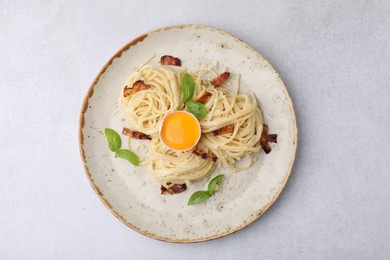 Photo of Delicious pasta Carbonara on grey table, top view