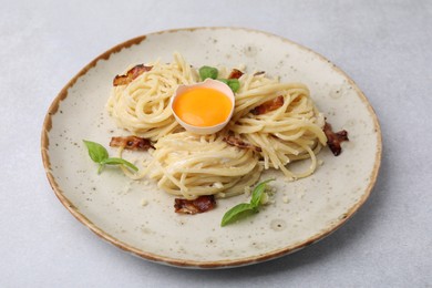 Photo of Delicious pasta Carbonara on grey table, closeup