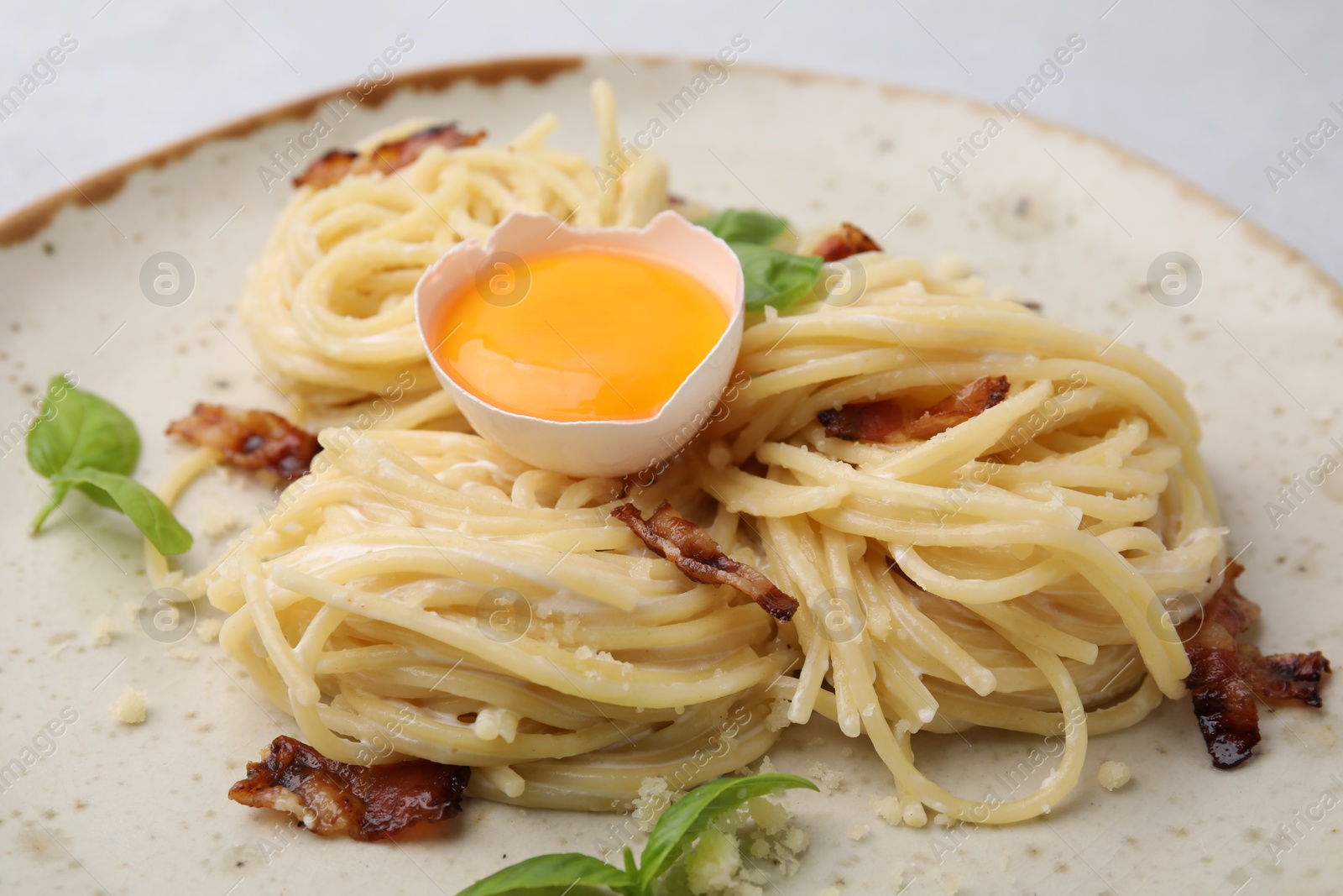 Photo of Delicious pasta Carbonara on grey table, closeup