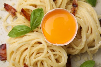 Photo of Delicious pasta Carbonara with egg yolk as background, closeup