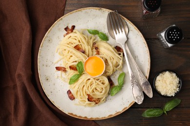 Photo of Delicious pasta Carbonara served on wooden table, top view